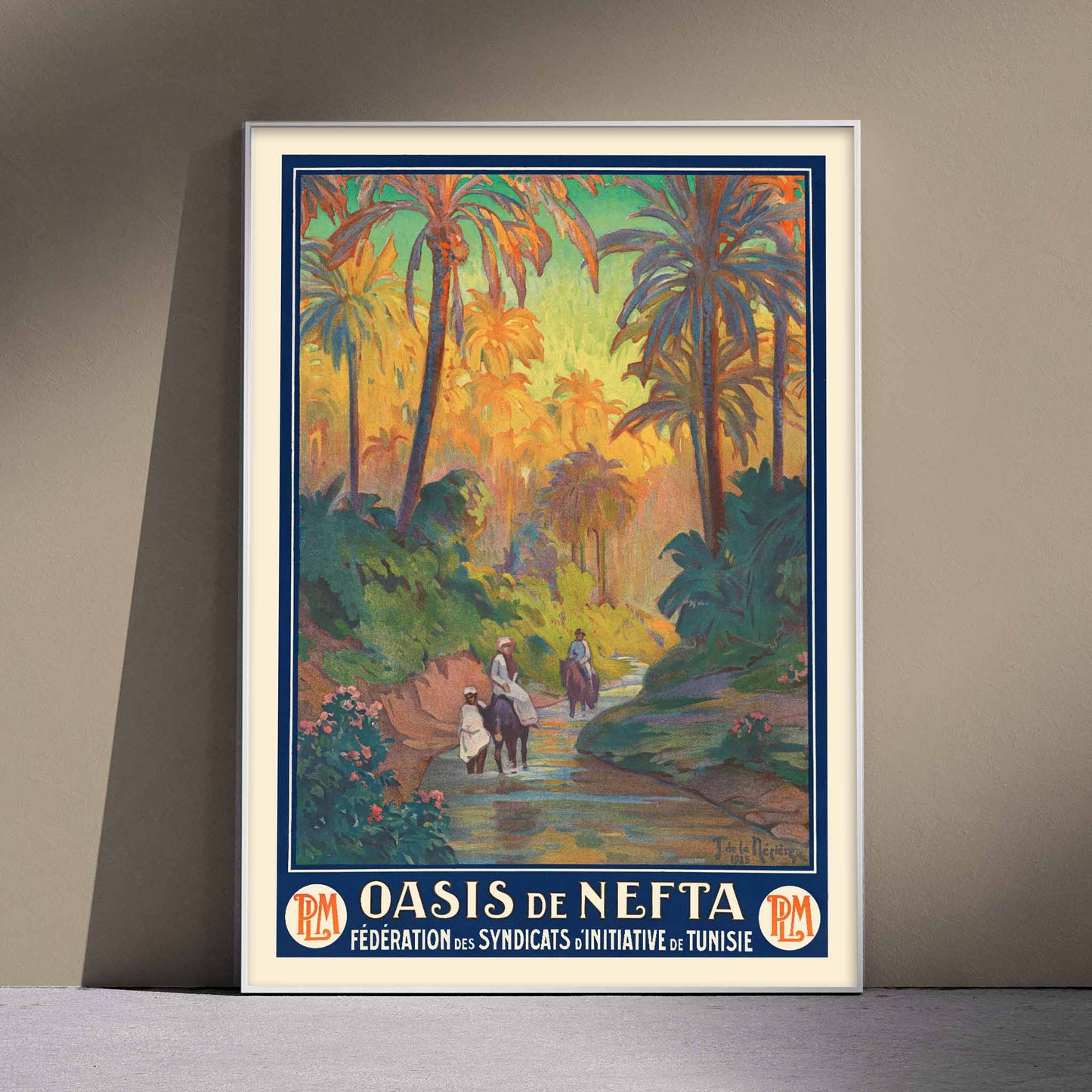Oasis de Nefta poster by Joseph de La Nézière with lush palm oasis, warm sunset light, figures and winding stream, with wooden magnetic frame on white background