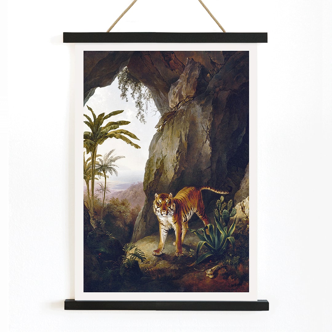 Tiger in a Cave painting by Jacques Laurent Agasse showing a tiger standing in a cave entrance surrounded by lush vegetation, with wooden magnetic frame on white background