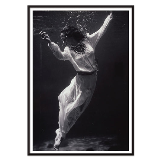 Black and white artwork of a fashion model floating underwater in dolphin tank Marineland Florida by Toni Frissell, with black aluminium frame on white background