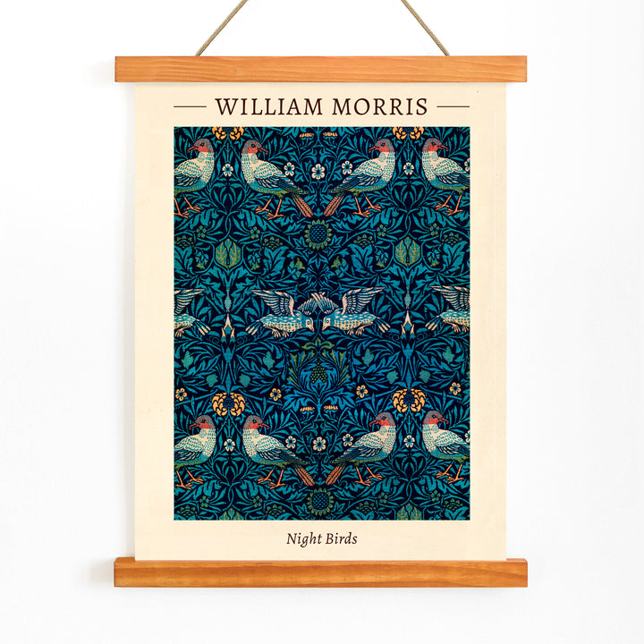 Night Birds by William Morris colorful patterned illustration and poster with intricate birds and floral designs in rich blue and green tones, with wooden magnetic frame on white background