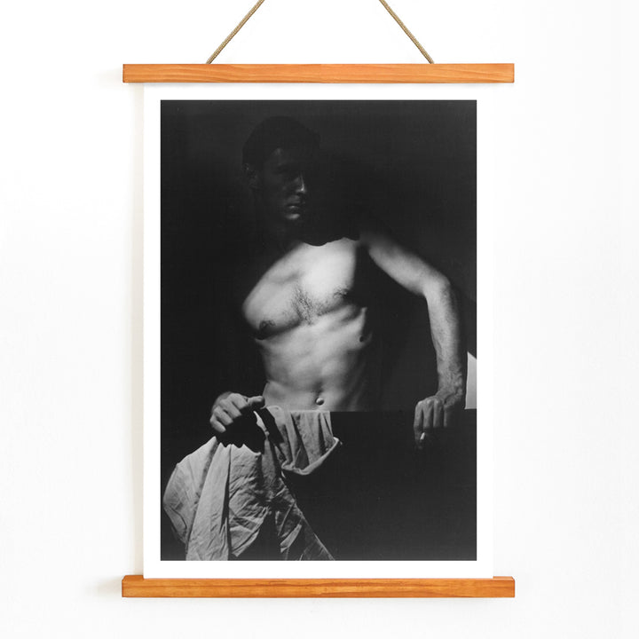 Shirtless man holding towel in dramatic lighting Max After Surfing by Olive Cotton wall art photography poster, with wooden magnetic frame on white background