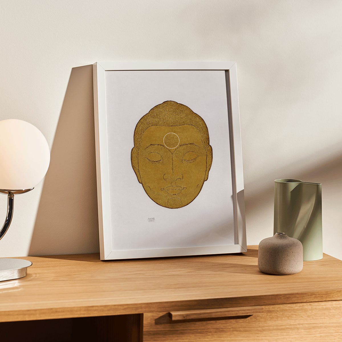 Serene golden Buddha head artwork with closed eyes by Reijer Stolk titled Head of Buddha on white background, framed and displayed in modern living room decor