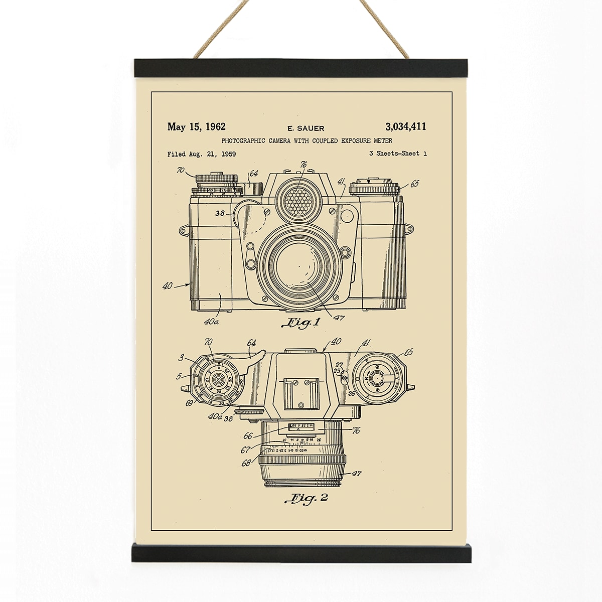 Technical illustration and poster of photographic camera with coupled exposure meter patent by E Sauer showing detailed technical drawings, with wooden magnetic frame on white background