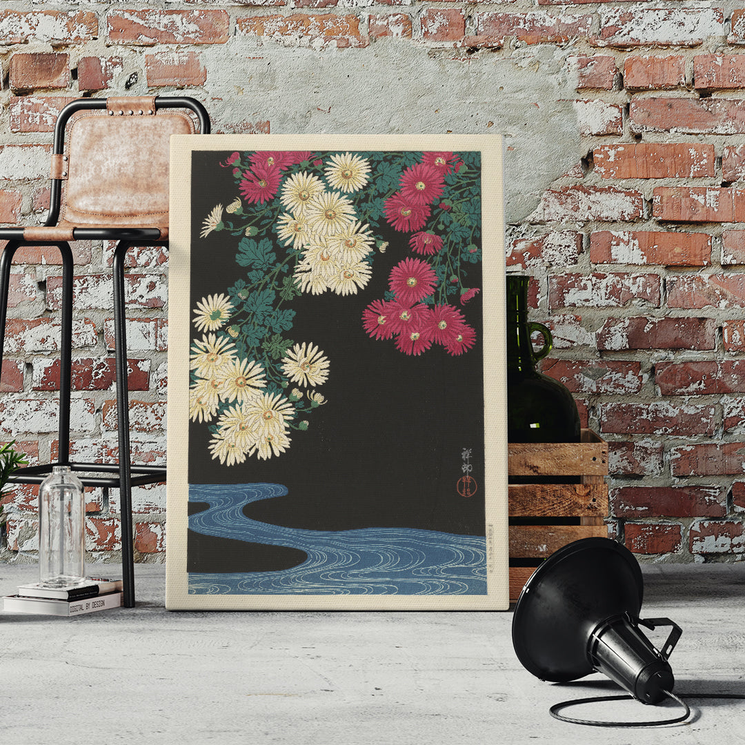 Chrysanthemums and Running Water by Ohara Koson Japanese art poster with yellow and pink flowers over blue water on black background, framed and displayed in home decor