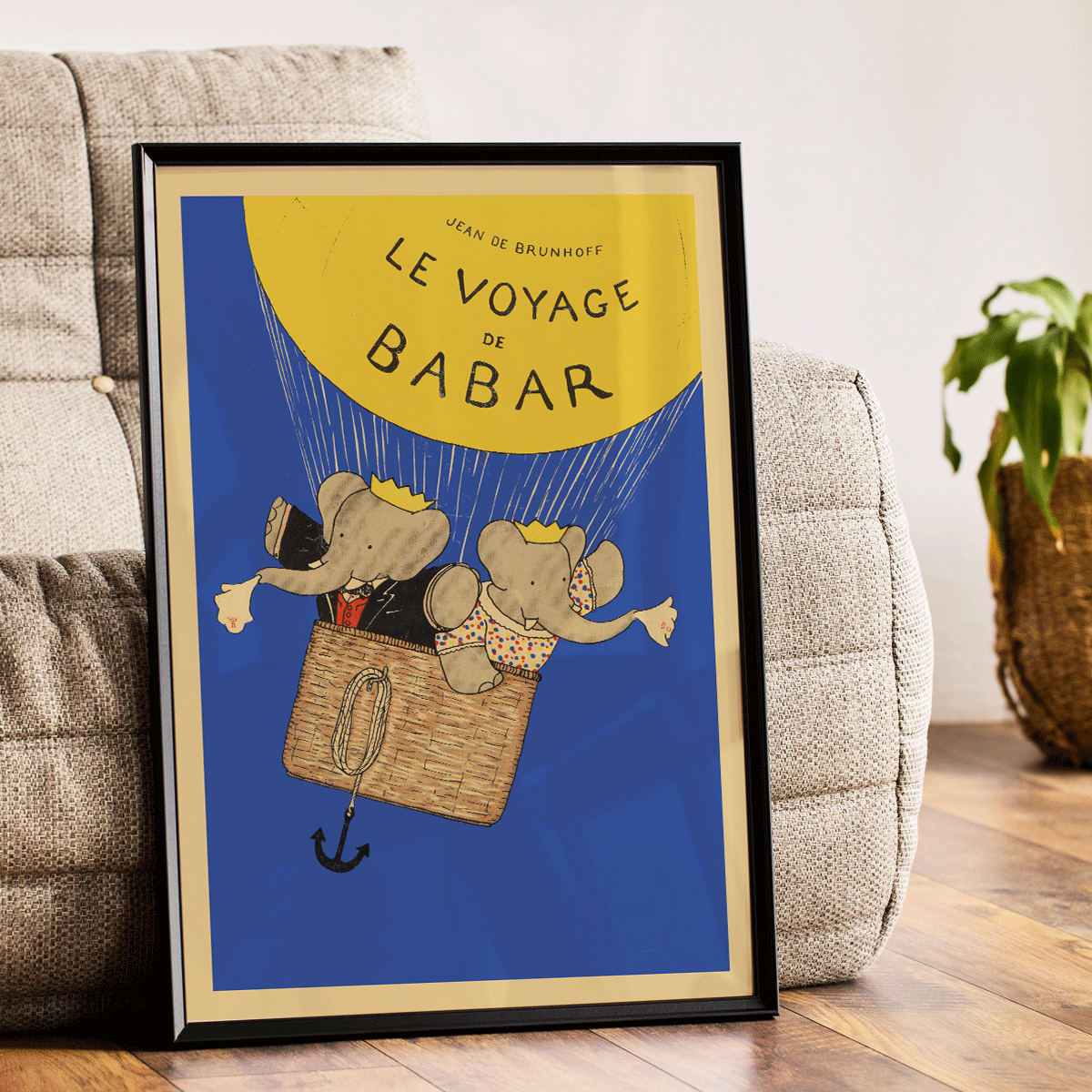 Le Voyage de Babar by Jean de Brunhoff illustration and poster featuring elephants in a hot air balloon with a yellow balloon on a blue background, framed and displayed in modern living room decor
