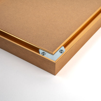 Golden aluminium photo frame with a classic, elegant design, featuring a smooth metallic finish and refined edges, suitable for displaying pictures or artwork., back corner closeup picture