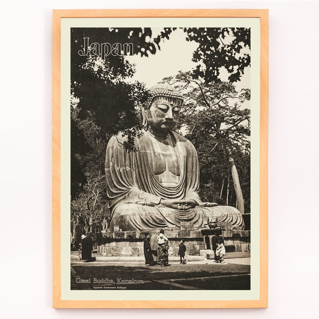 Japan travel poster by Japanese Government Railways showing the Great Buddha in Kamakura with people near the large statue, framed and displayed in modern living room decor