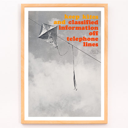 Closeup detail of Black and white photo and poster of a kite tangled on a telephone line with bold warning text Keep kites and classified information off telephone lines