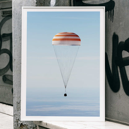 Soyuz MS-02 spacecraft descending with parachute over Kazakhstan NASA poster titled The Soyuz MS-02 spacecraft lands, framed and displayed in home decor