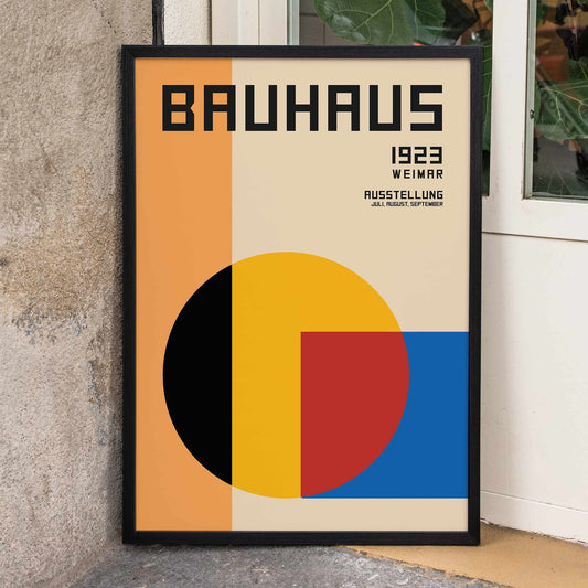 Bauhaus Poster 1 inspired by the Weimar Exhibition featuring geometric shapes in warm bold colors and modernist design style, framed and displayed in home decor