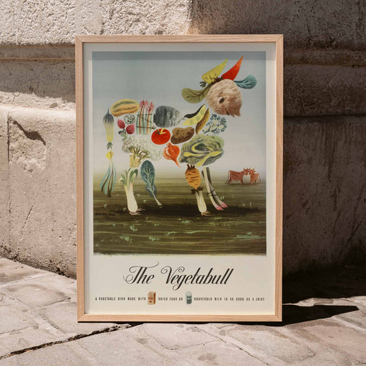 The Vegetabull by Lewitt-Him painting and poster showing a bull made of vegetables on grass background, framed and displayed in home decor