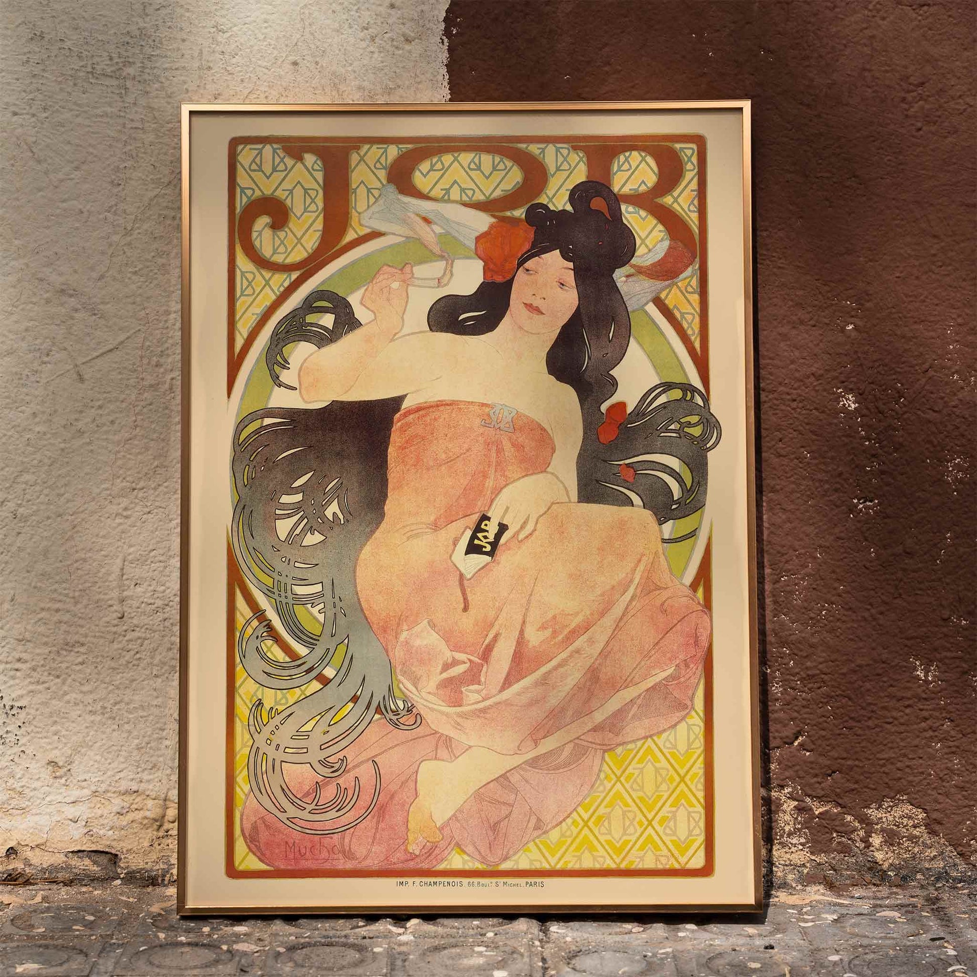 Art Nouveau poster by Alphonse Mucha featuring an elegant woman in a flowing dress with dark hair titled Job, framed and displayed in home decor