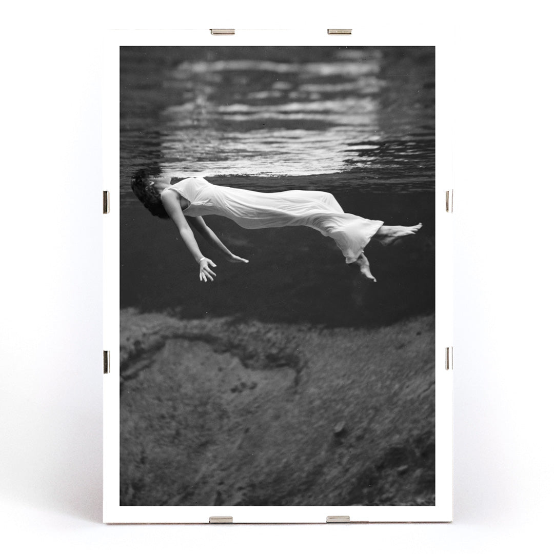 Underwater woman in white flowing dress at Weeki Wachee spring Florida by Toni Frissell, framed and displayed in modern living room decor