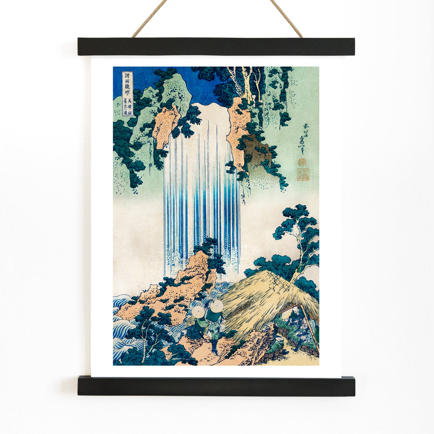 Yoro Waterfall in Mino Province by Katsushika Hokusai featuring lush greenery figures trees rocks and people in straw hats, with wooden magnetic frame on white background