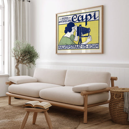 Vintage art deco poster of a woman using a vintage camera at Capi Camera Shop by Johann Georg van Caspel, framed and displayed in home decor